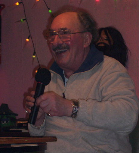 Gordon Cragg seated at bingo table and smiling broadley